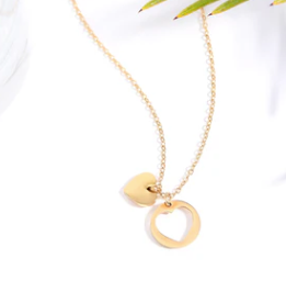 Gold necklace with heart-shaped pendants on a white background